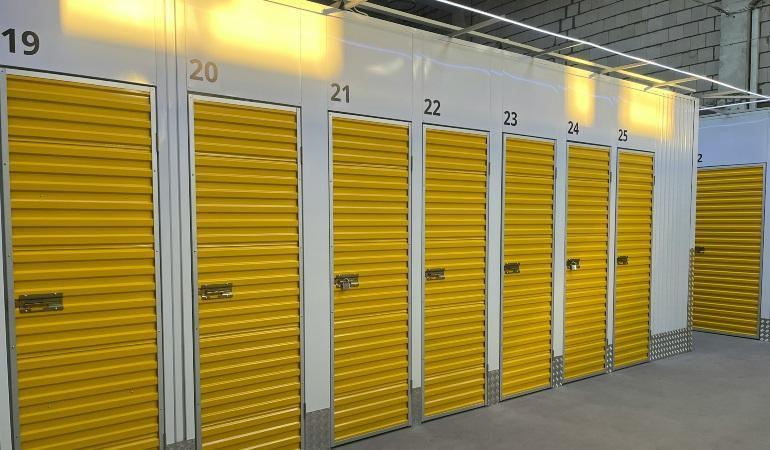 Row of storage units with yellow doors.