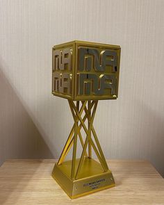 This contains an image of K-pop award in a gold color 