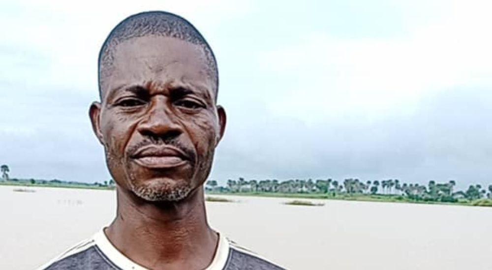 A victim standing in his flooded farm at Okpanku