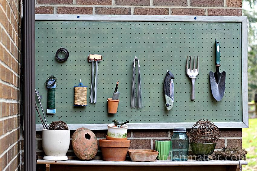 A pegboard with garden tools. It is one of the 7 garden storage hacks every gardener should know.