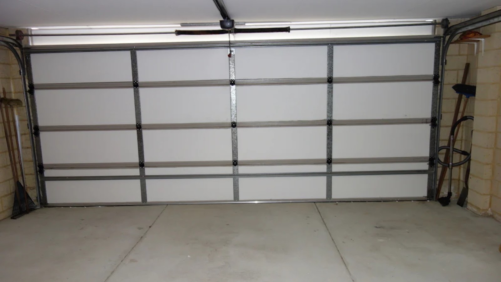 A fully closed insulated sectional garage door with a durable metal frame.