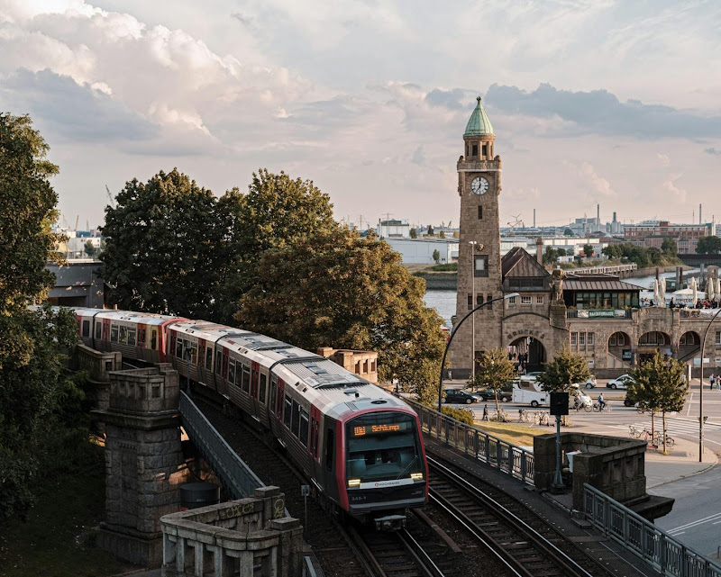 brown and white train on rail road near brown concrete building during daytime