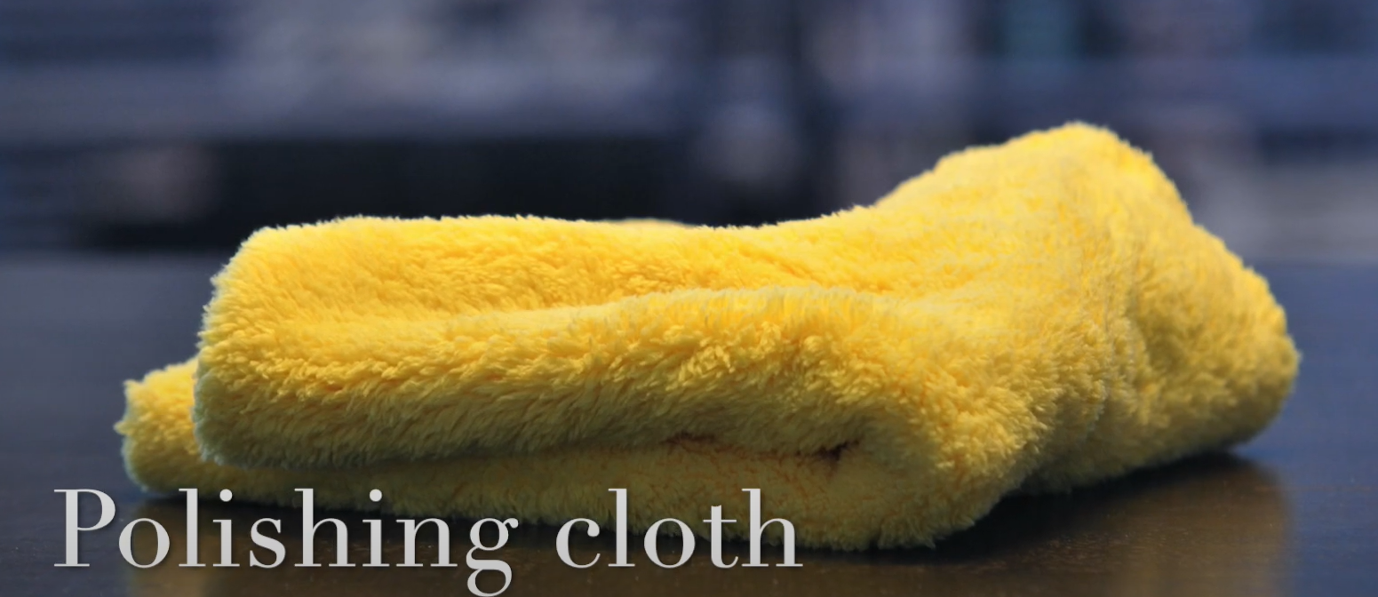 Yellow microfiber cloth used for polishing surfaces.