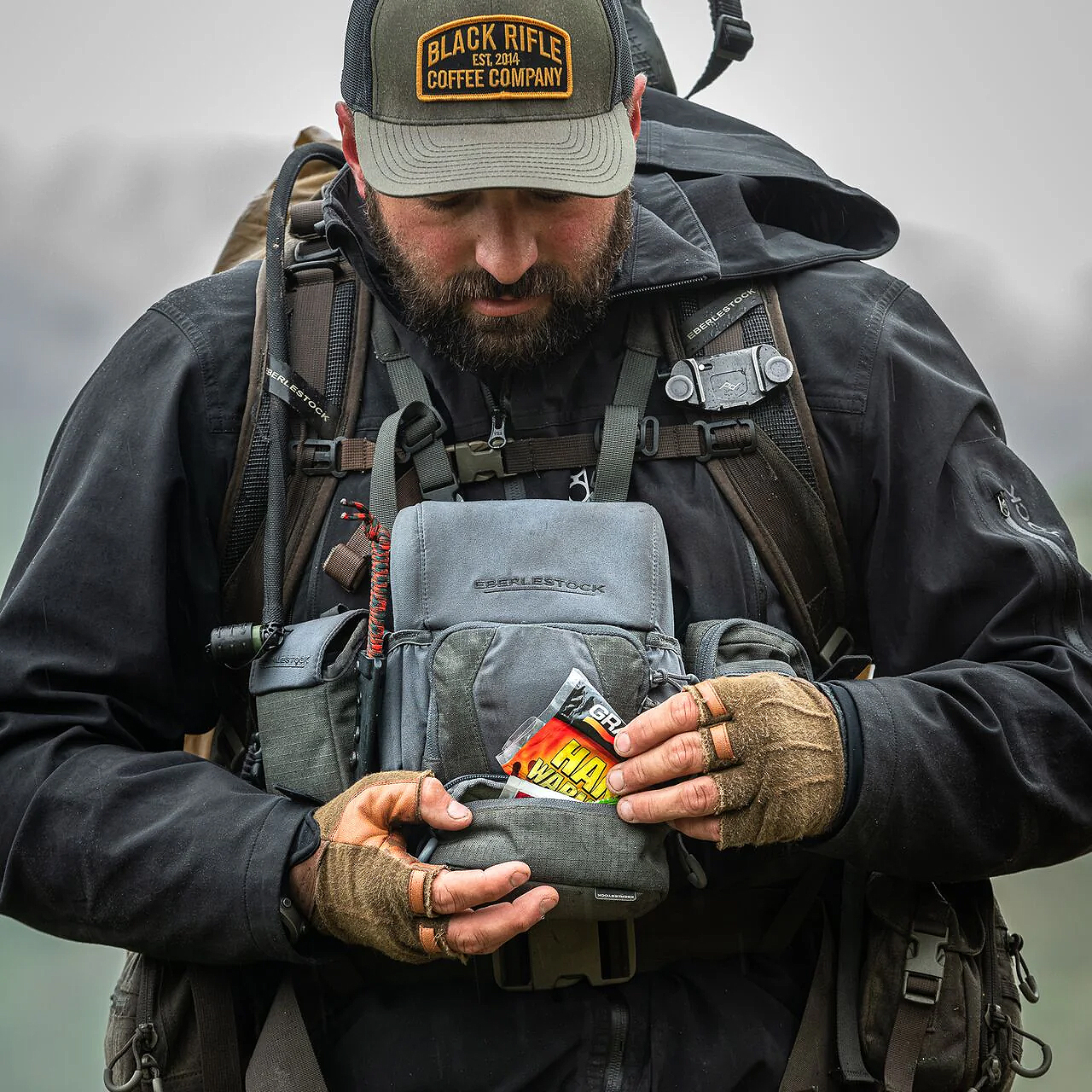 hunter using the Eberlestock Recon Quickcase to store a piece of Hand warmer fabric