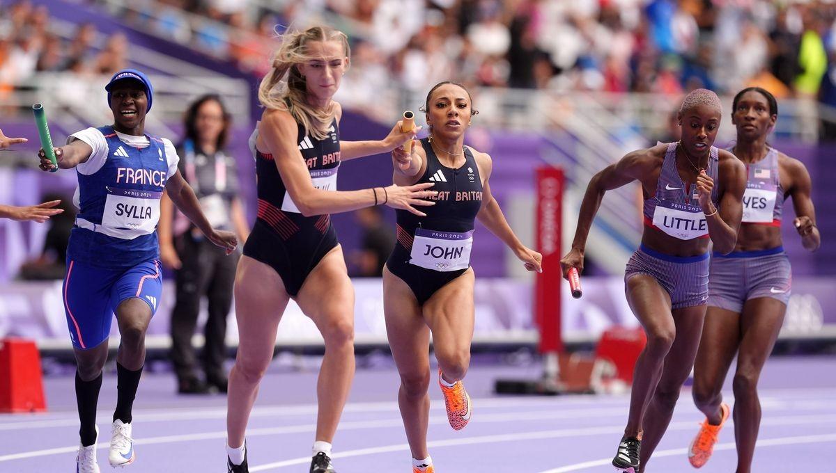 A group of women running on a track

Description automatically generated