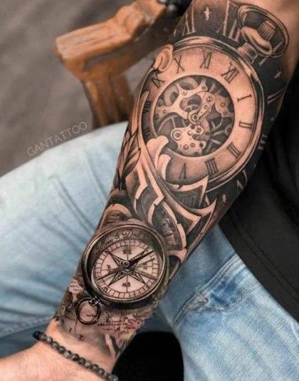 Forearm tattoo featuring detailed design of a pocket watch and compass, highlighting intricate timekeeping elements.