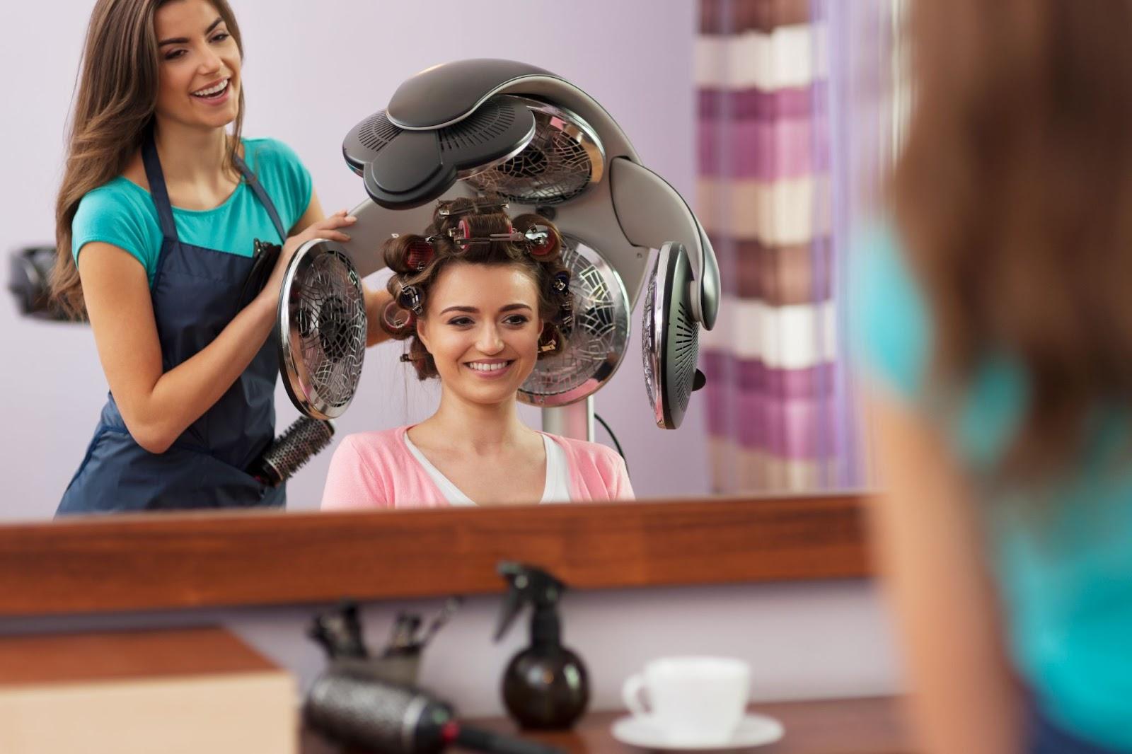 Female client at salon with rollers on her hair