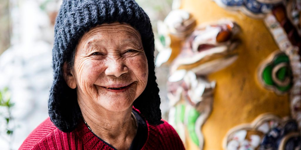 a person smiling with a hat