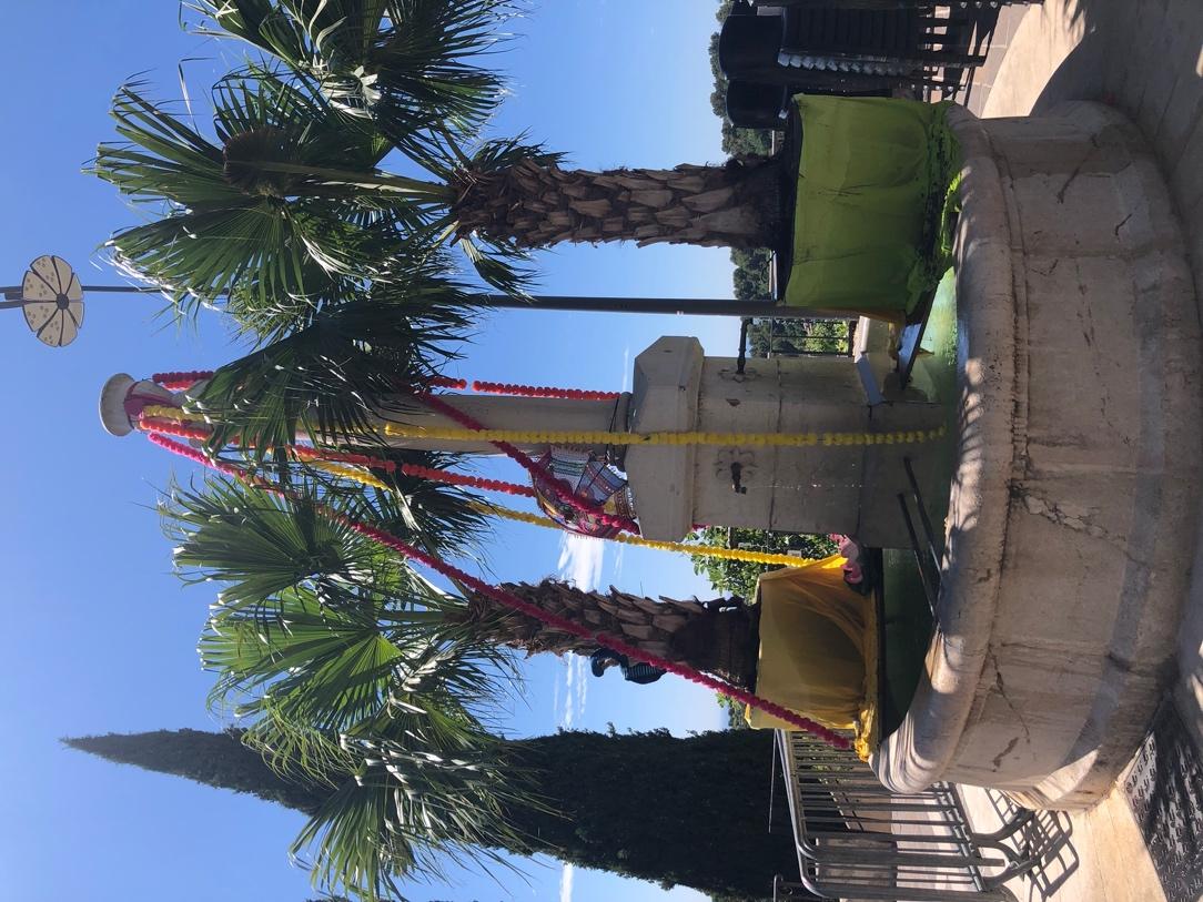 A fountain with palm trees

Description automatically generated