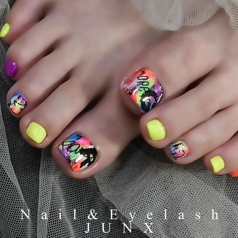 Close up of foot with radiant Graffiti toe Nails