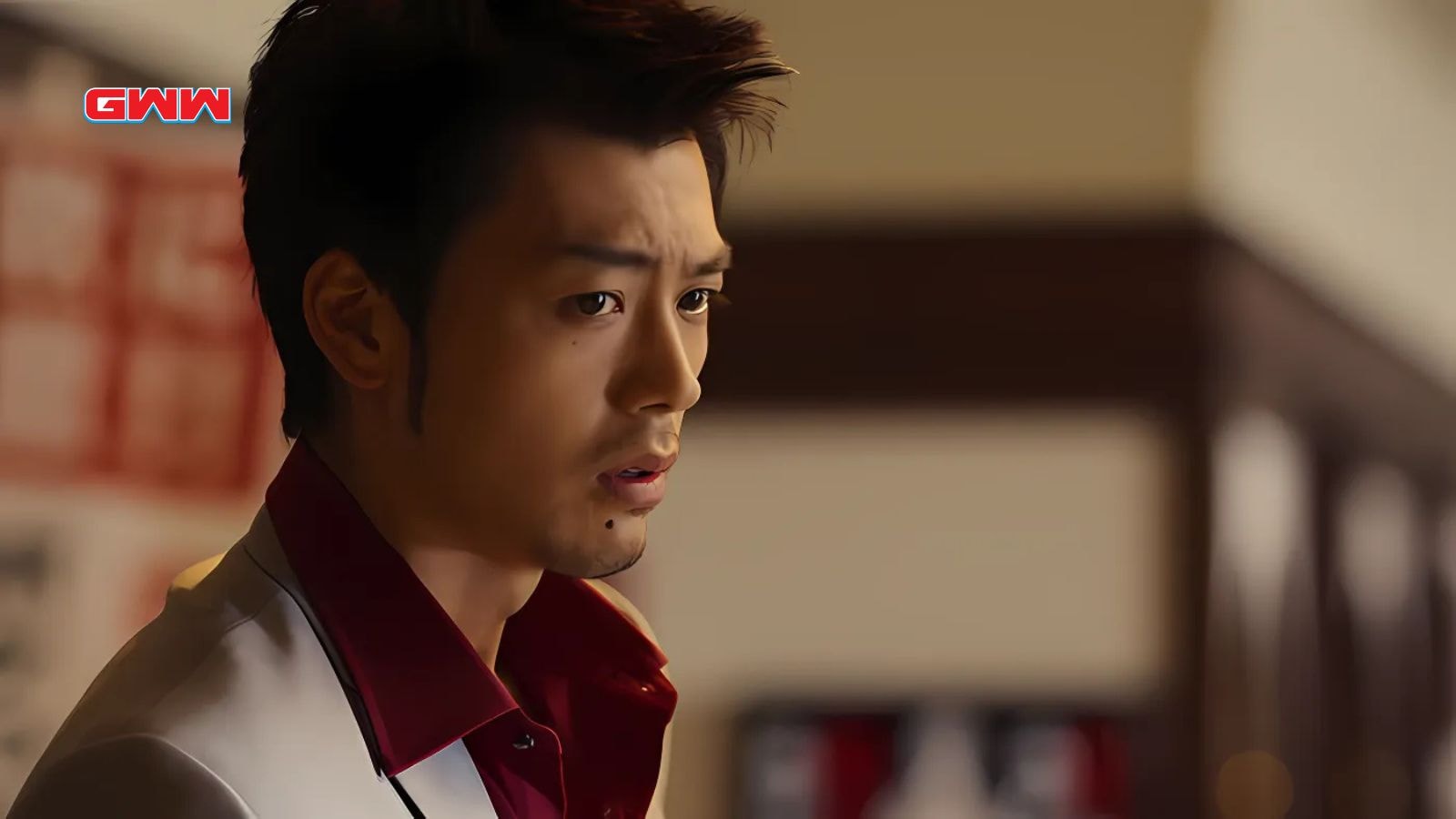 Ryoma Takeuchi as Kazuma Kiryu, looking concerned in a white suit.