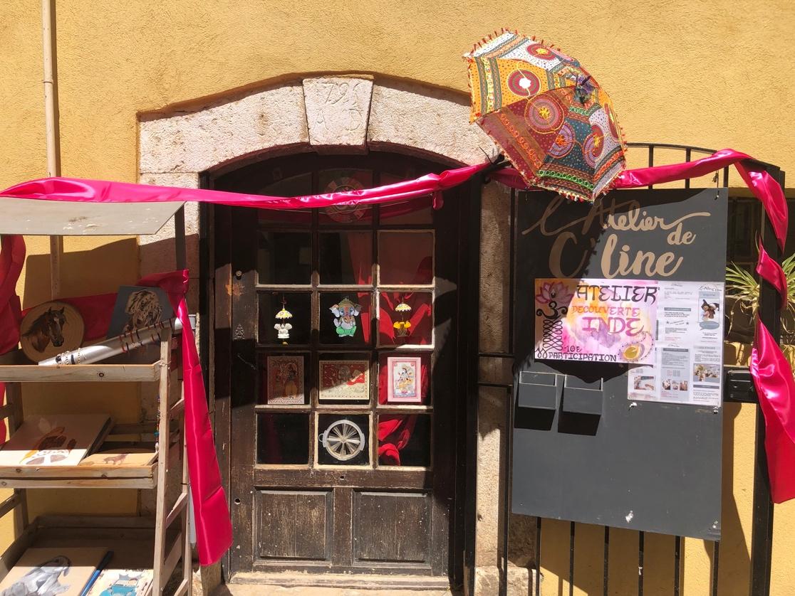 A door with umbrellas and signs

Description automatically generated