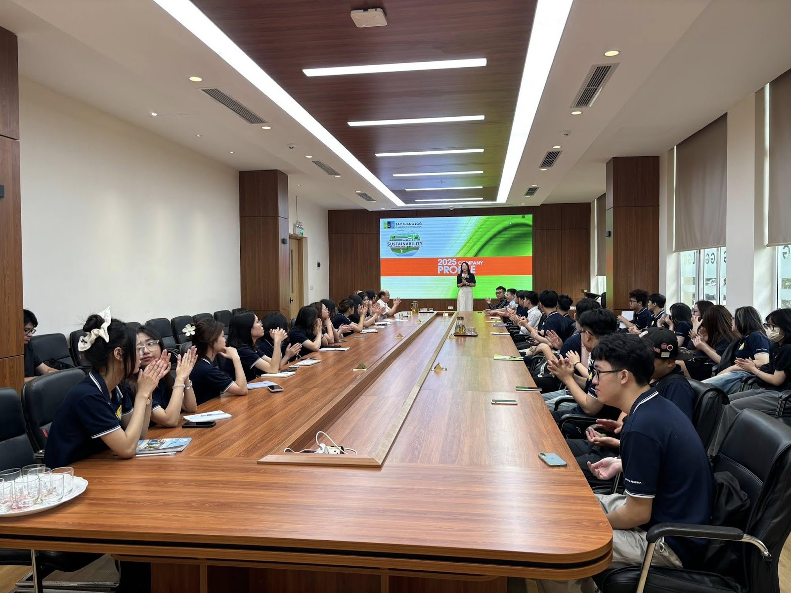 A group of people sitting at a long table

Description automatically generated