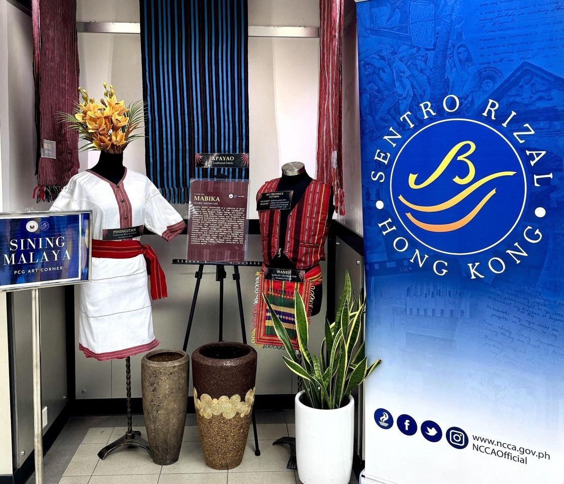 A display of clothing and flowersDescription automatically generated