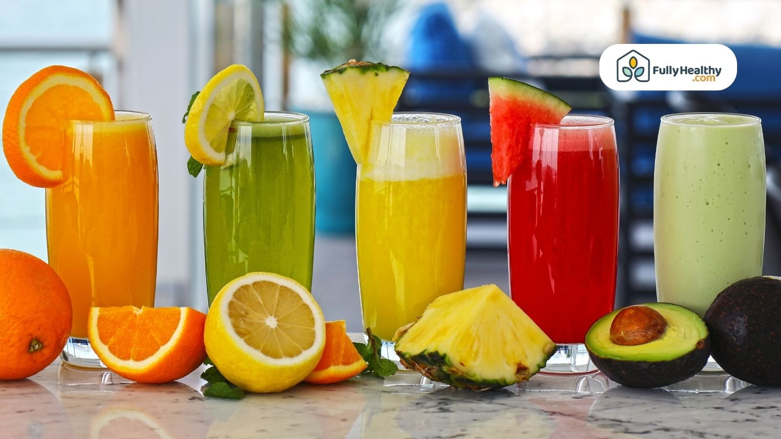 Colorful fruit juices in glasses with its fruits on table