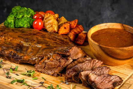 A meat and vegetables on a cutting board

AI-generated content may be incorrect.