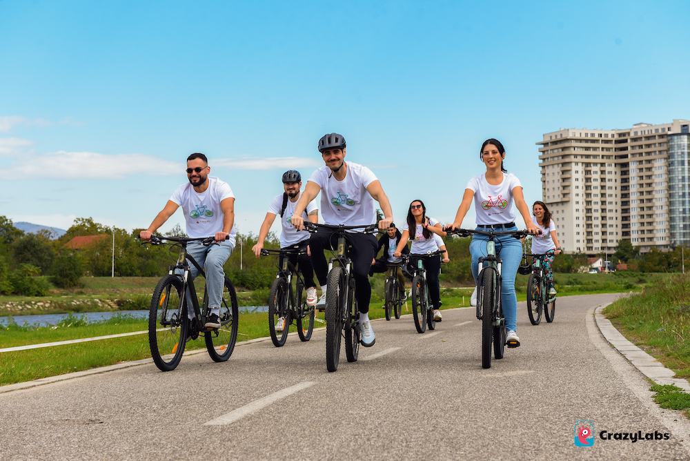 A group of people riding bicycles on a road

Description automatically generated