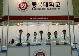 A group of people standing in front of a sign

AI-generated content may be incorrect.