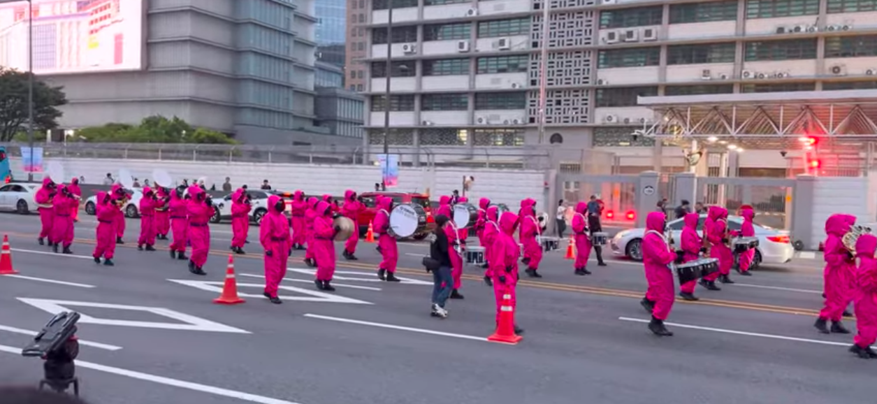 This contains an image of Squid Game Seoul parade
