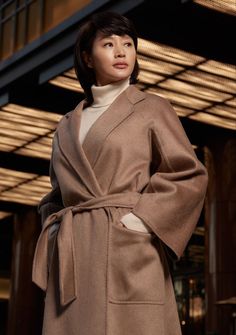 This may contain: a Kim Hye Soo wearing a brown coat and turtle neck sweater