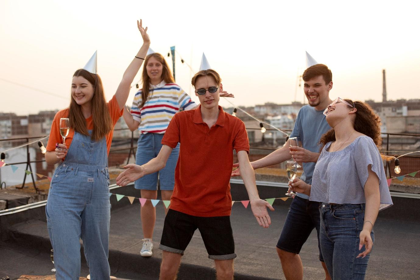 A group of people dancing on a rooftop

Description automatically generated