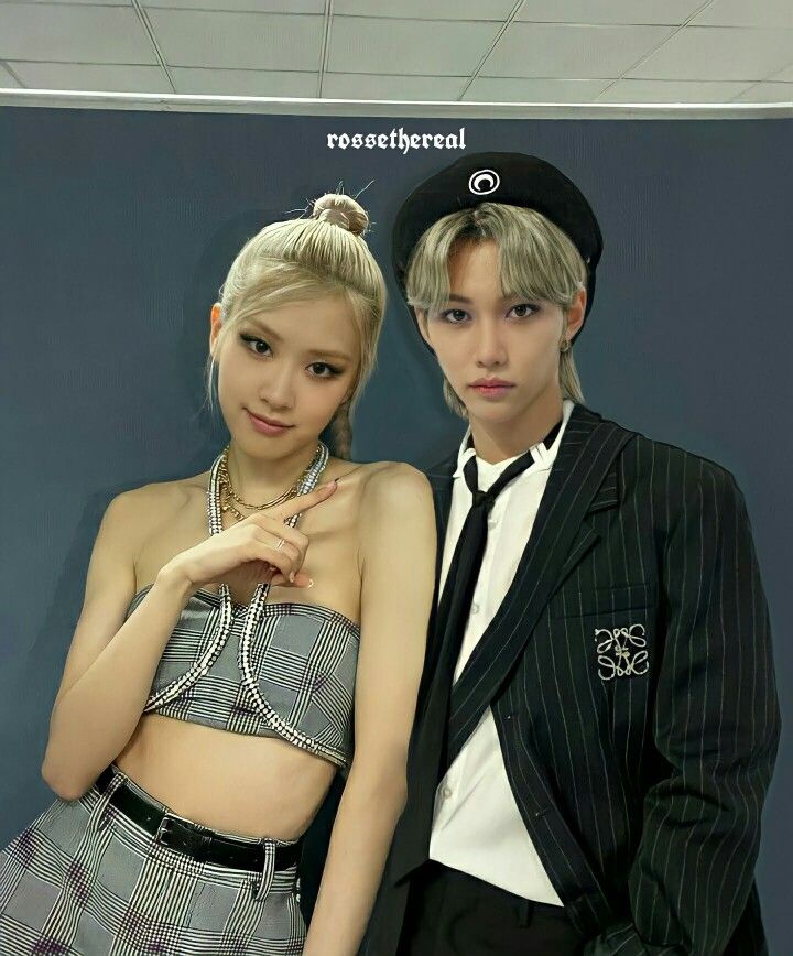 This contains an image of Stray Kids Felix And BLACKPINK Rosé standing next to each other in front of a blue wall and black background