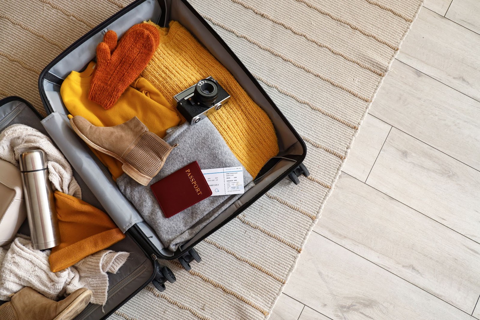 Suitcase packed with winter clothing