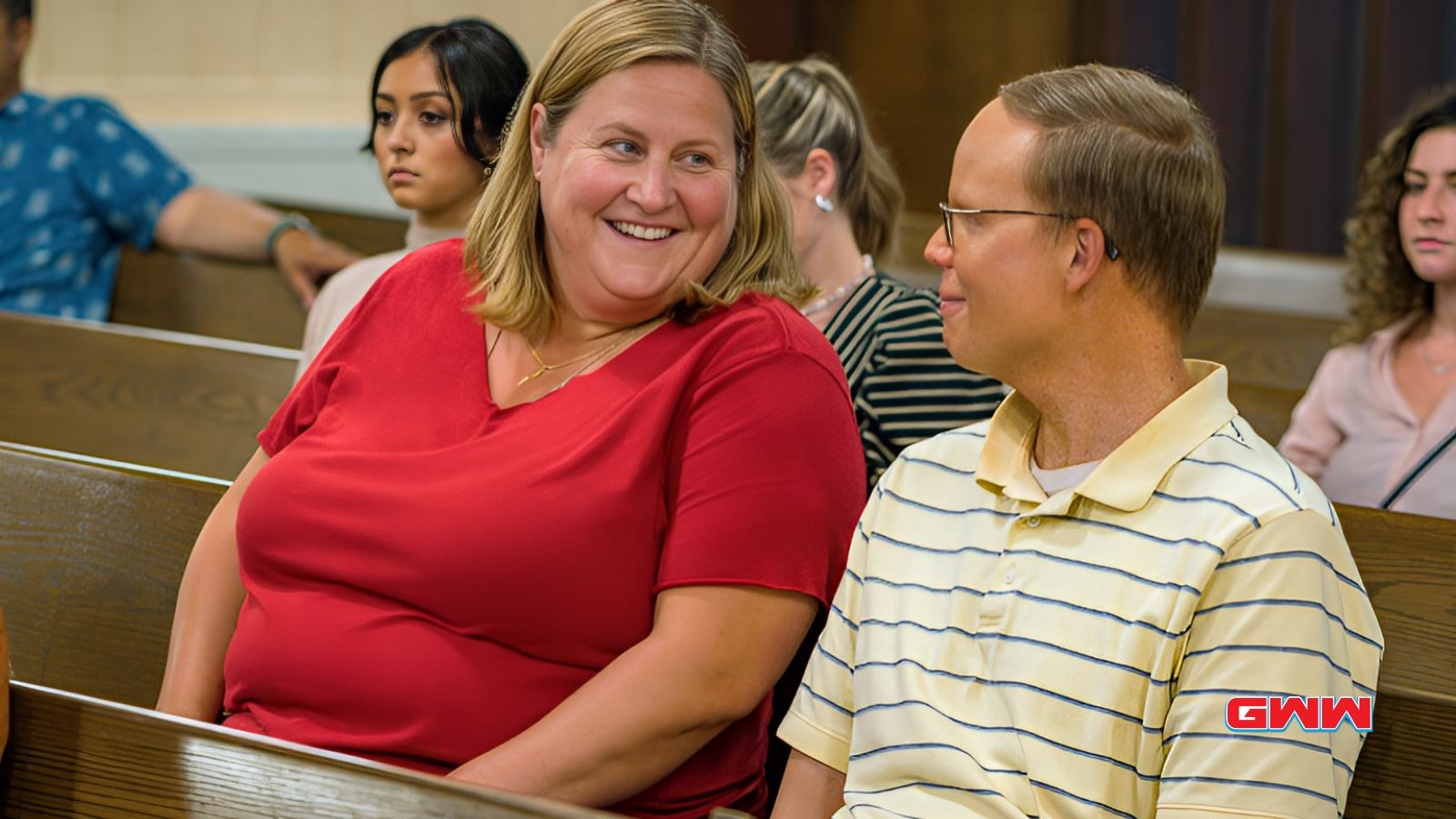 Bridget Everett and Jeff Hiller sitting in a church in Somebody Somewhere