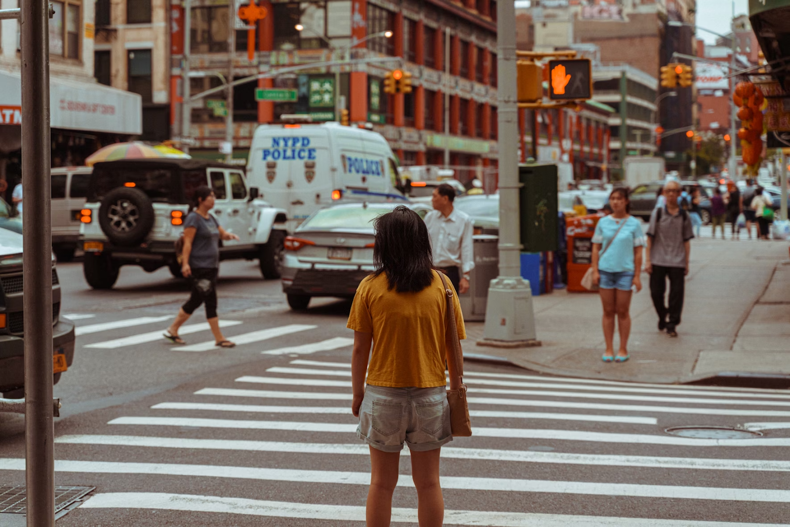 Woman in yellow shirt standing on the street