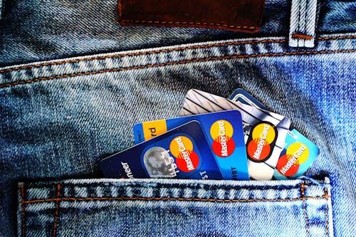 Free Close-up of a denim pocket with multiple credit cards, illustrating finance and fashion. Stock Photo