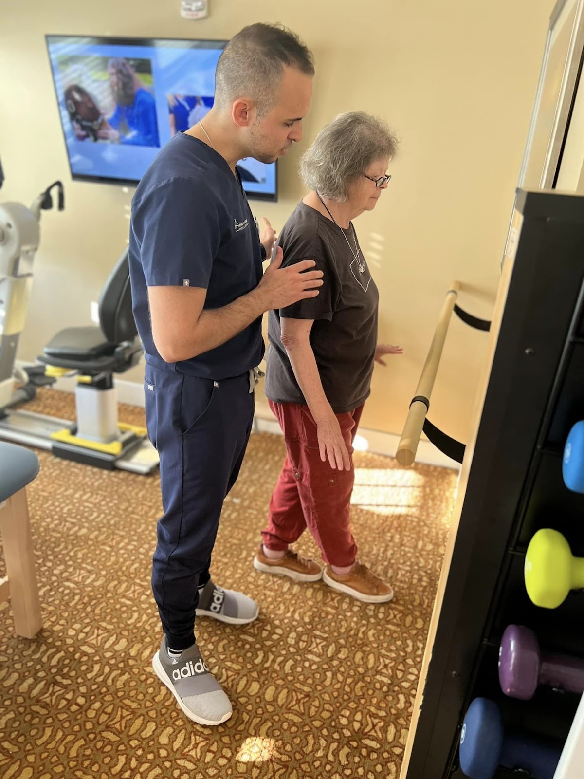 A Village Walk physical therapist helping a senior citizen do a hell-to-toe walk