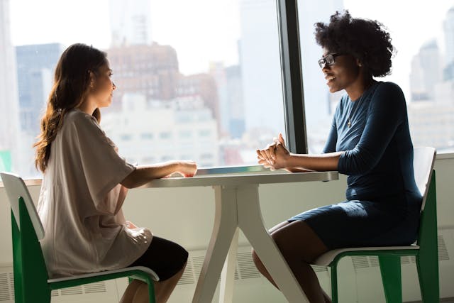 Two people speaking together