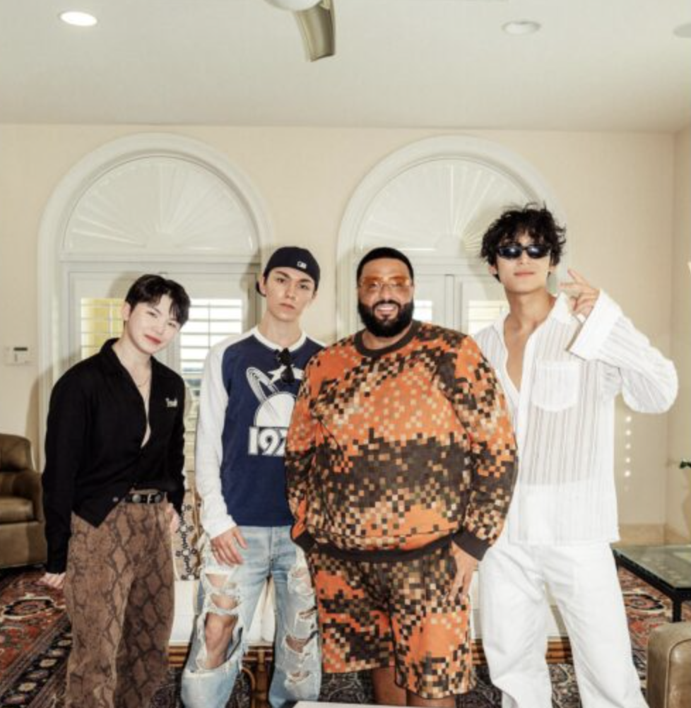 A photo of DJ Khaled  with SEVENTEEN members Mingyu, Vernon, and Woozi.

