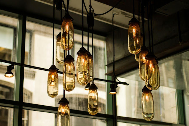 Black pendant lamps with beige glass bulbs, NYC.