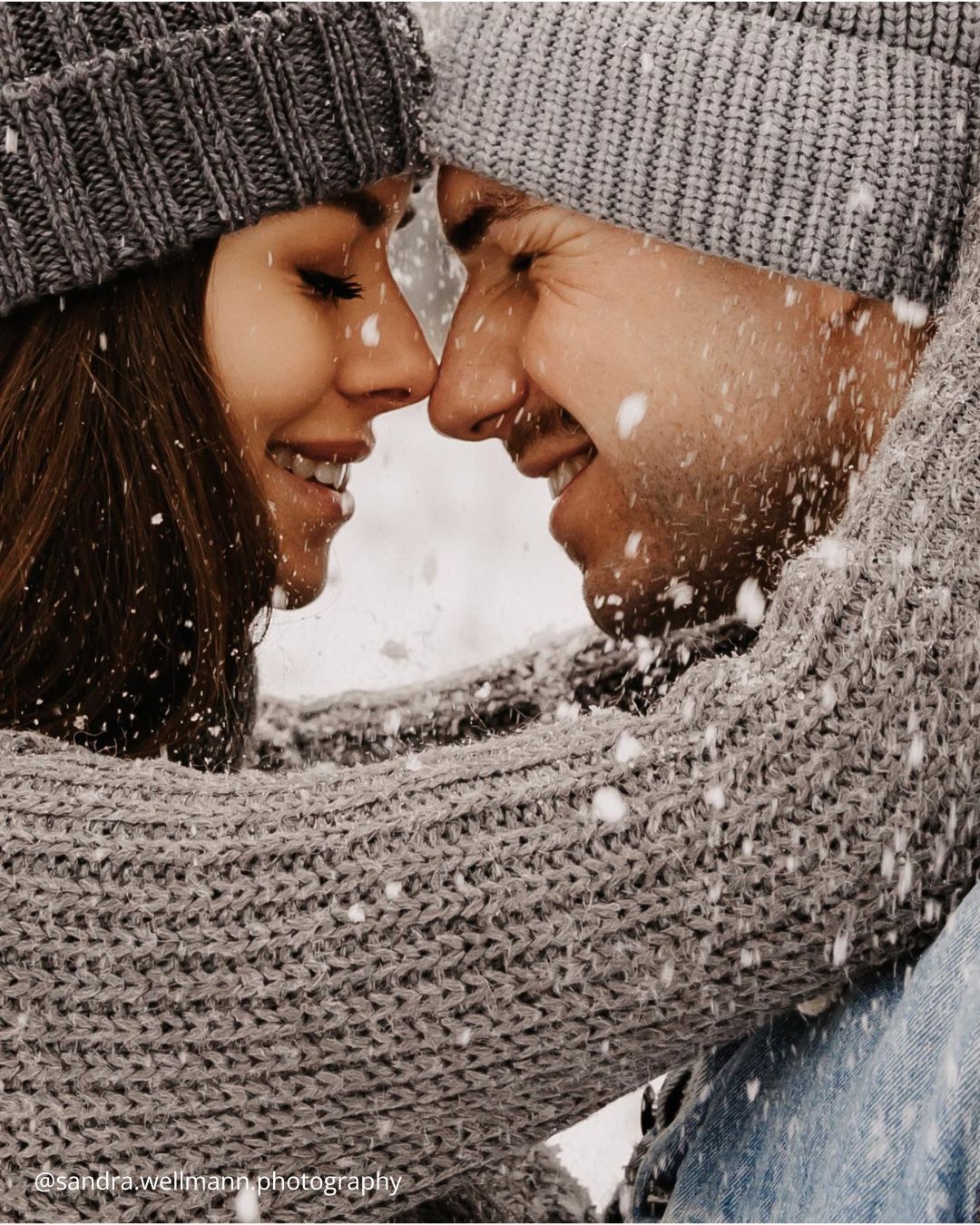 winter engagement photos close up photo of a couple hugging in the snow