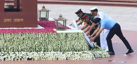 A group of people placing flowers on a tableDescription automatically generated
