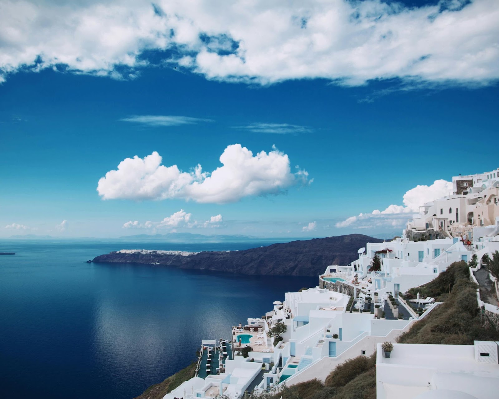 Santorini's white buildings with blue domes overlooking the island.