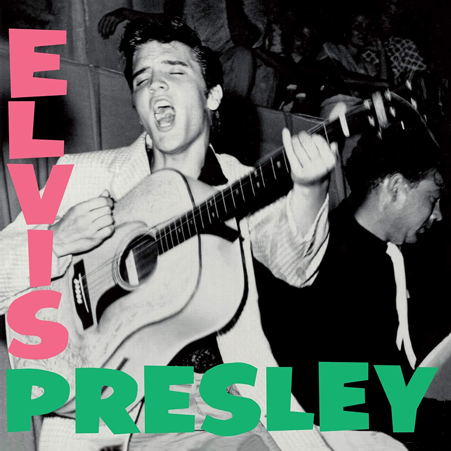 Elvis Presley's self-titled album cover featuring a black-and-white image of the singer mid-performance, strumming a guitar and singing, with his name in bold pink and green text.