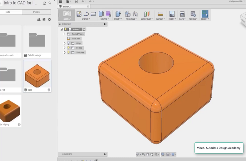 A 3D model of a cube with a hole in Fusion 360.








