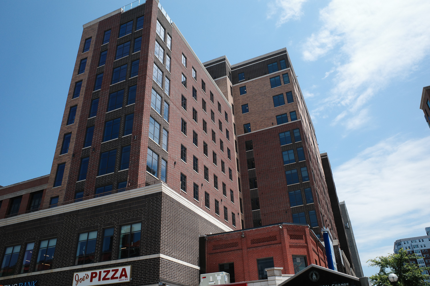 High rise apartment in Ann Arbor with sign reading "Joe's Pizza."