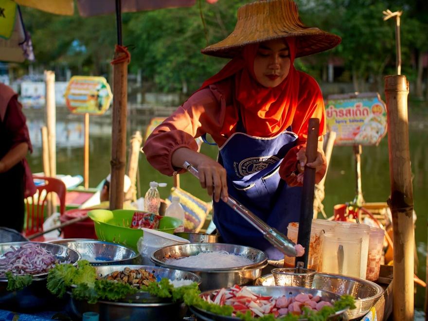 A person cooking food at a street food stand AI-generated content may be incorrect.
