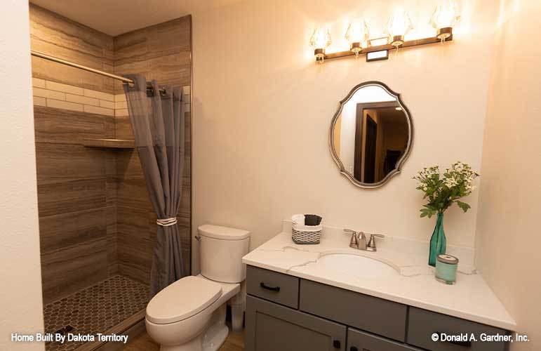 Bathroom with a sink vanity, a toilet, and a walk-in shower.