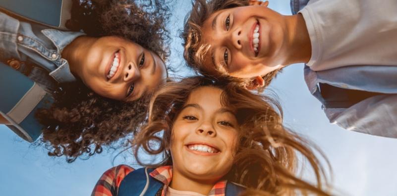 A group of kids looking downDescription automatically generated
