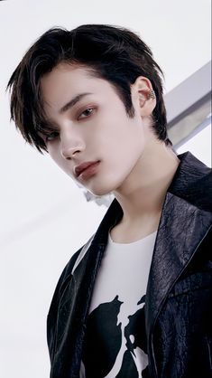 This may contain of  TXT Hueningkai  with black hair wearing a white t - shirt and leather jacket 