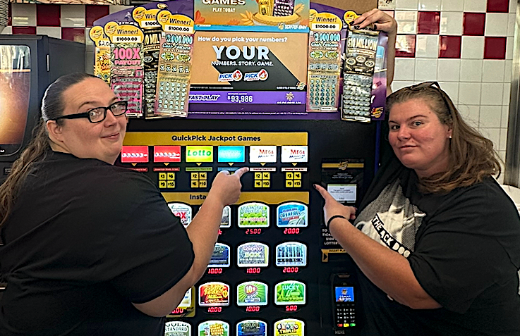 Store manager, Stephanie Noteboom (right), takes a celebratory photo with co-worker, Brittany McDaniel, after selling a $1 million winning Mega Millions ticket.