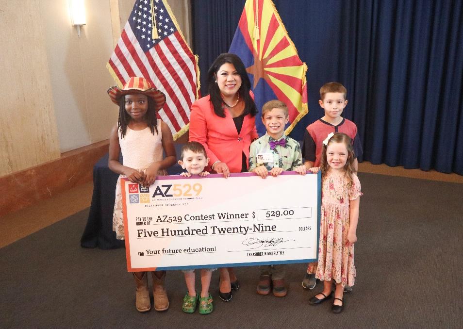 A group of children holding a check