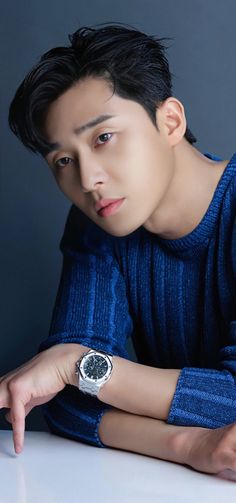 This contains an image of Park Seo Joon wearing a blue sweater 