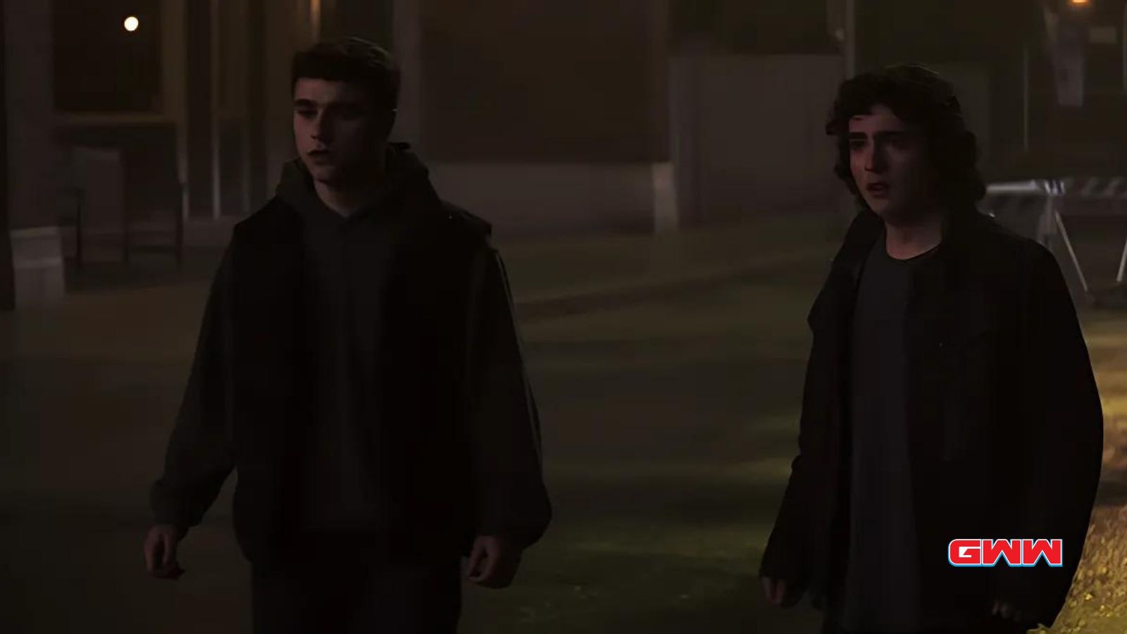 Alex Garfin and Michael Bishop walking together in a tense nighttime scene