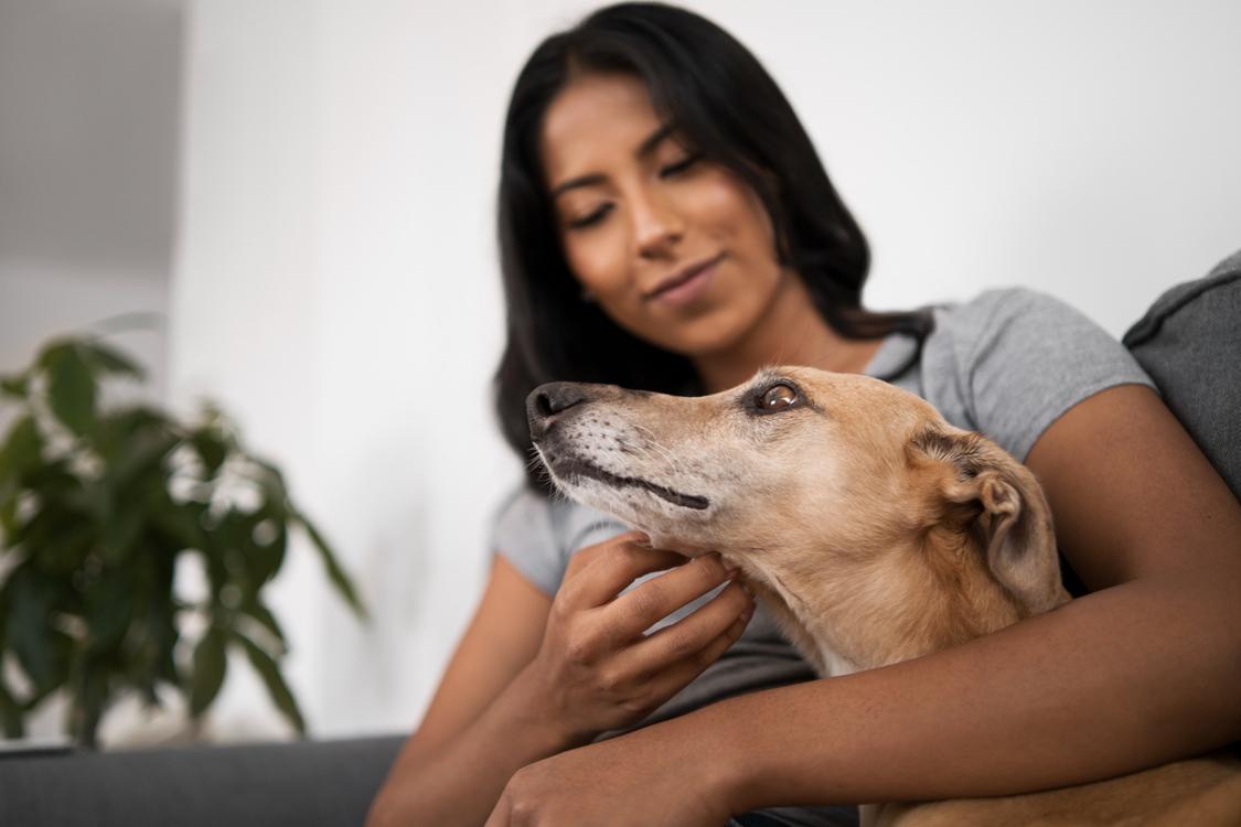 A pet parent showing her care to her dog