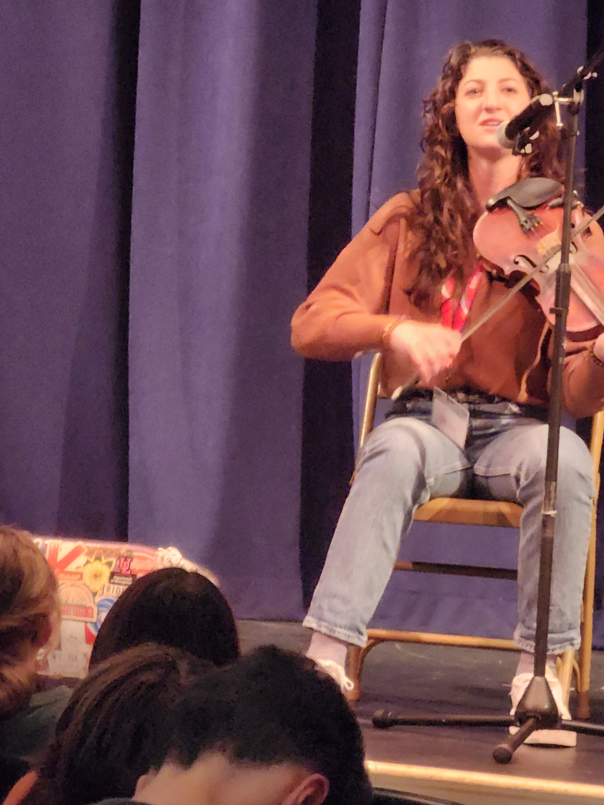person in a chair playing violin